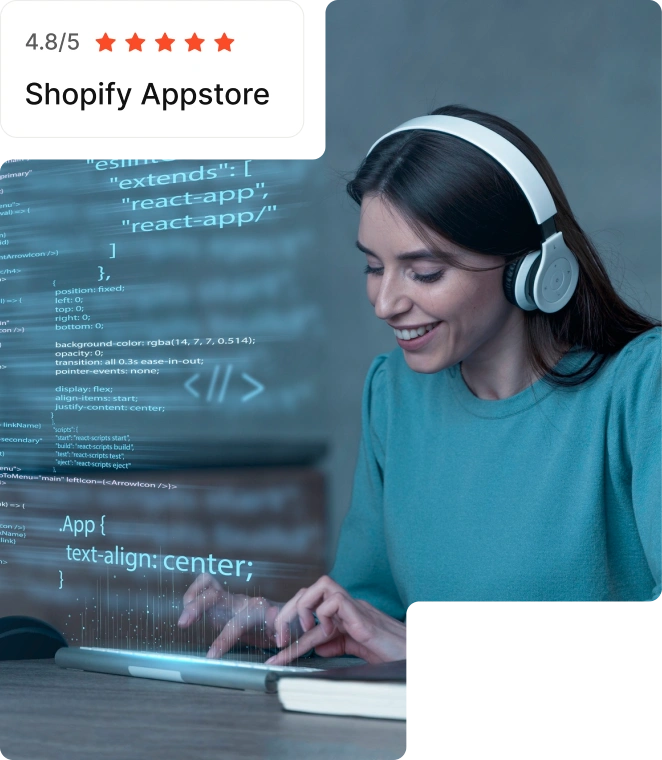 A woman with headphones smiles while working on a laptop