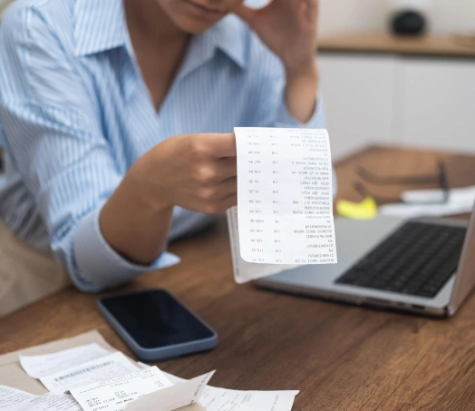 Woman checking long receipt